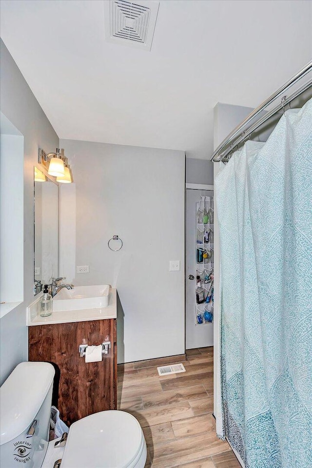 1112 Kim Ct, Joliet, IL 60431 - bathroom with vanity, wood finished floors, and a shower with shower curtain