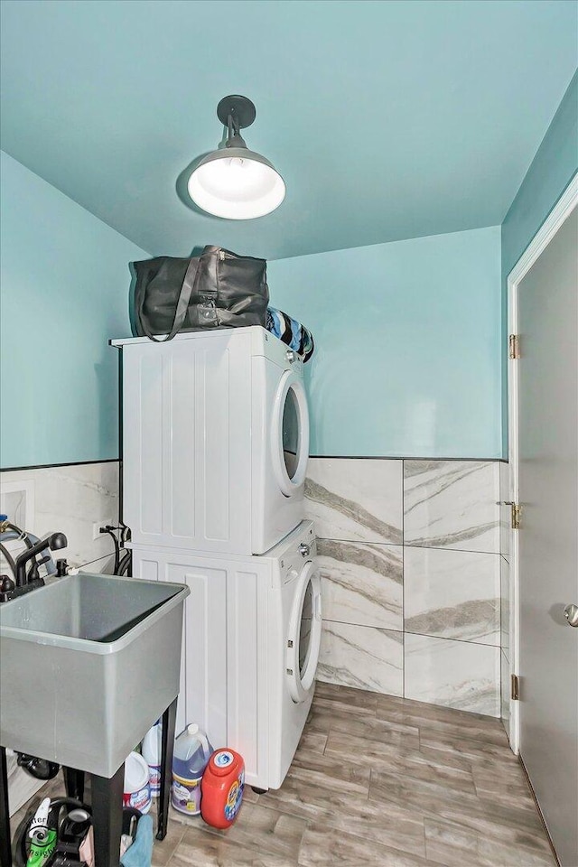 1112 Kim Ct, Joliet, IL 60431 - laundry room featuring stacked washer / dryer and wood finished floors