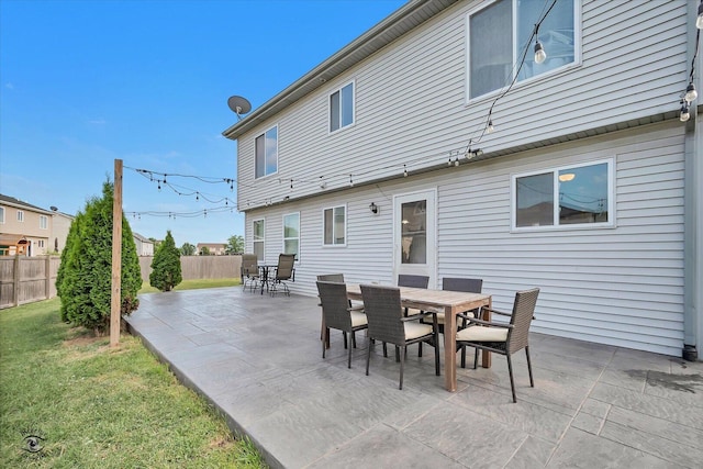 1112 Kim Ct, Joliet, IL 60431 - rear view of house with outdoor dining area, a patio, and a fenced backyard