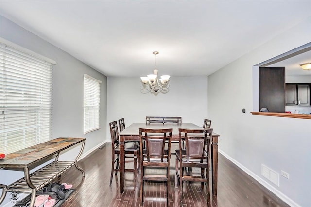 1112 Kim Ct, Joliet, IL 60431 - dining space featuring a chandelier and dark wood-style flooring