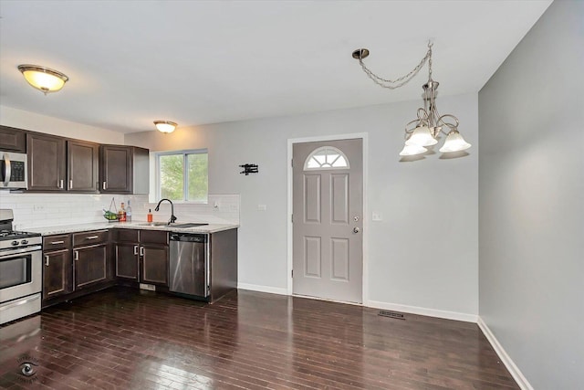 1112 Kim Ct, Joliet, IL 60431 - kitchen with stainless steel appliances, dark brown cabinets, and dark wood-style floors