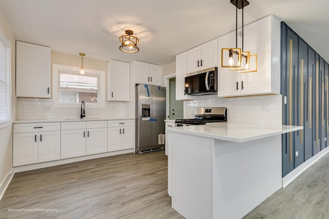 15223 Cottage Grove Ave, Dolton, IL 60419 - kitchen with stainless steel appliances, light wood finished floors, a peninsula, and white cabinets
