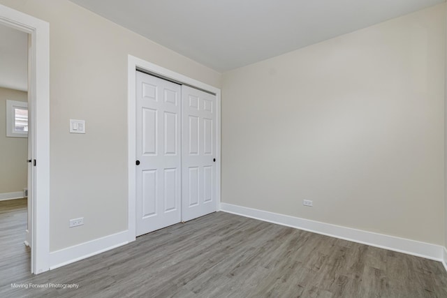 15223 Cottage Grove Ave, Dolton, IL 60419 - unfurnished bedroom with wood finished floors and a closet