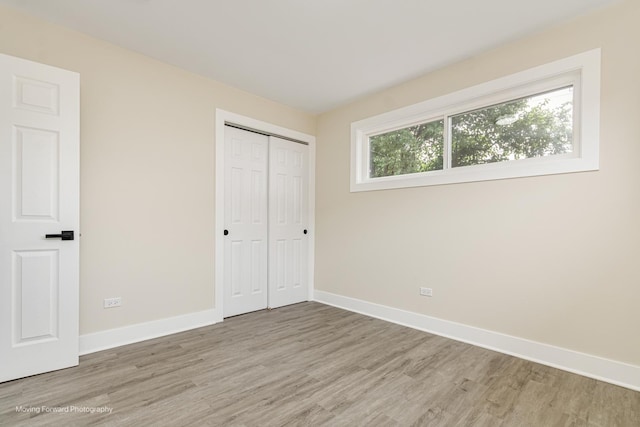 15223 Cottage Grove Ave, Dolton, IL 60419 - unfurnished bedroom with light wood-style flooring and a closet