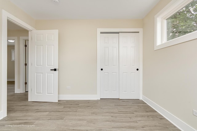 15223 Cottage Grove Ave, Dolton, IL 60419 - unfurnished bedroom featuring light wood-style flooring and a closet