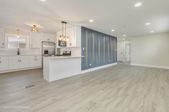15223 Cottage Grove Ave, Dolton, IL 60419 - kitchen with stainless steel appliances, backsplash, white cabinets, light wood-style flooring, and recessed lighting