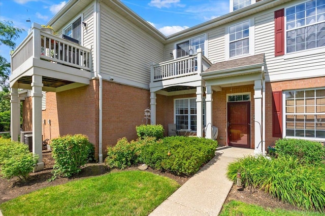 2201 Concord Dr Unit 2201, Mchenry, IL 60050 - property entrance featuring a balcony and brick siding