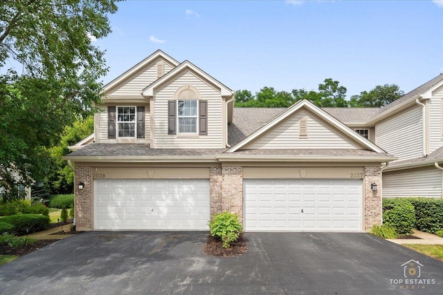 2039 Muirfield Dr, Yorkville, IL 60560 - traditional-style house featuring brick siding, driveway, a shingled roof, and an attached garage