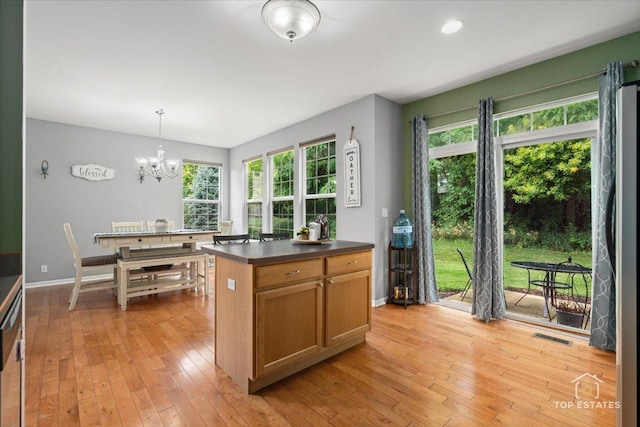 2039 Muirfield Dr, Yorkville, IL 60560 - kitchen featuring a chandelier, dark countertops, light wood-type flooring, and hanging light fixtures