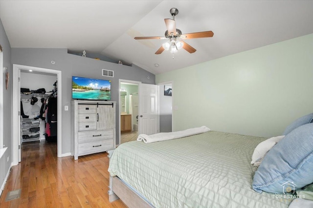 2039 Muirfield Dr, Yorkville, IL 60560 - bedroom featuring a walk in closet, lofted ceiling, light wood-type flooring, a ceiling fan, and ensuite bathroom
