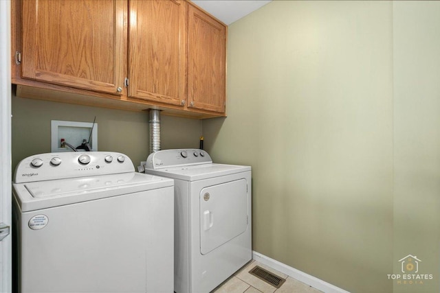 2039 Muirfield Dr, Yorkville, IL 60560 - laundry area featuring cabinet space, washer and clothes dryer, and light tile patterned flooring