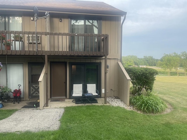 64 Aspen Colony Unit 5, Fox Lake, IL 60020 - rear view of property featuring a balcony, a yard, and roof with shingles