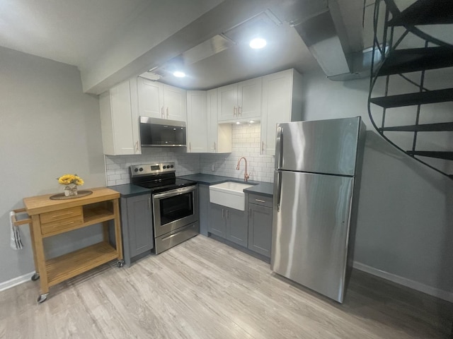 64 Aspen Colony Unit 5, Fox Lake, IL 60020 - kitchen featuring appliances with stainless steel finishes, light wood-style floors, and dark countertops