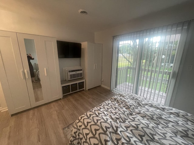64 Aspen Colony Unit 5, Fox Lake, IL 60020 - unfurnished bedroom featuring access to outside, wood finished floors, and a wall mounted AC