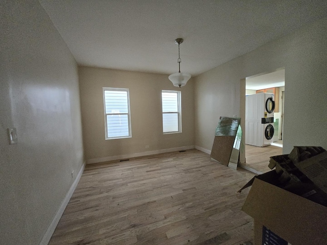 426 N Trumbull Ave, Chicago, IL 60624 - dining space with stacked washer / drying machine and light wood-type flooring