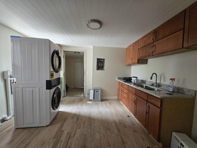 426 N Trumbull Ave, Chicago, IL 60624 - laundry room with estacked washer and dryer, light wood-type flooring, and wooden ceiling