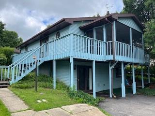 71 Delburne Dr, Davis, IL 61019 - view of side of home with a wooden deck, stairway, and a sunroom