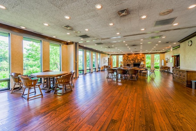 1401 Burr Oak Rd Unit 108B, Hinsdale, IL 60521 - dining area featuring ornamental molding, hardwood / wood-style floors, and a stone fireplace