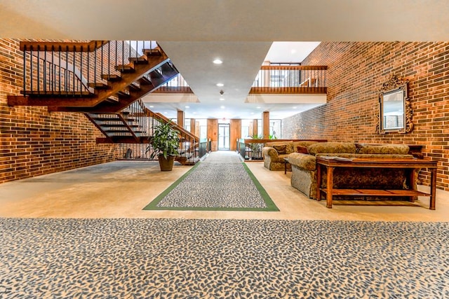 1401 Burr Oak Rd Unit 108B, Hinsdale, IL 60521 - lobby with a towering ceiling, brick wall, and stairs