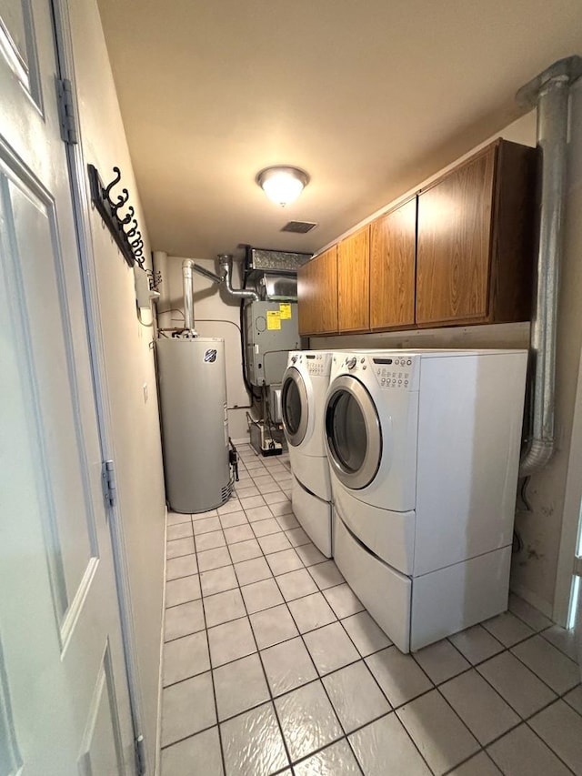 2S651 Ashley Dr, Glen Ellyn, IL 60137 - laundry area with water heater, cabinet space, independent washer and dryer, and light tile patterned floors
