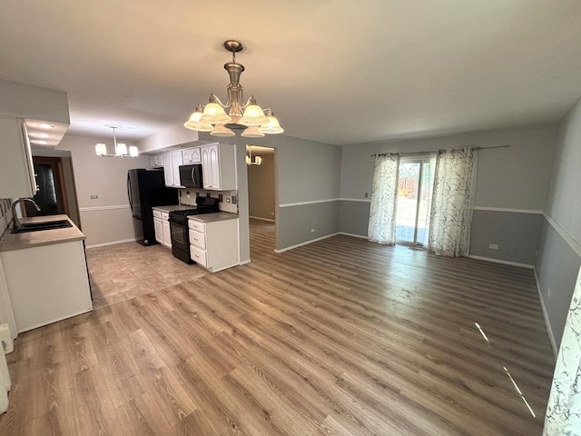 2S651 Ashley Dr, Glen Ellyn, IL 60137 - kitchen with a chandelier, black appliances, white cabinets, and light wood-type flooring