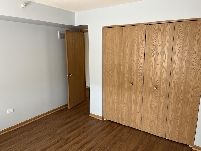 2020 Saint Regis Dr Unit 501, Lombard, IL 60148 - unfurnished bedroom with dark wood-style floors and a closet