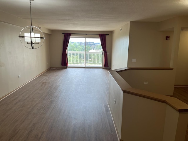2020 Saint Regis Dr Unit 501, Lombard, IL 60148 - spare room featuring wood finished floors, a chandelier, and a textured ceiling
