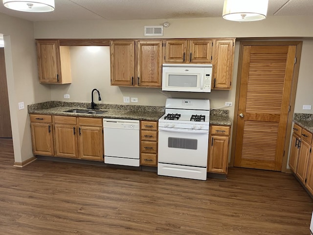2020 Saint Regis Dr Unit 501, Lombard, IL 60148 - kitchen with white appliances, dark wood-type flooring, brown cabinets, and dark stone counters
