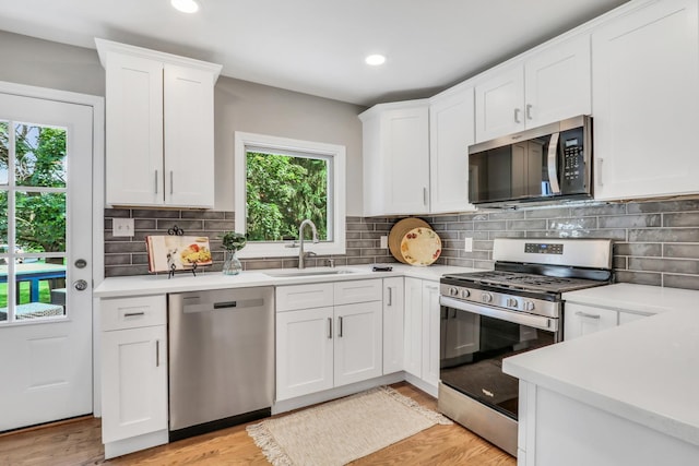 31340 N Liberty Rd, Grayslake, IL 60030 - kitchen with stainless steel appliances, light countertops, white cabinetry, light wood-type flooring, and recessed lighting