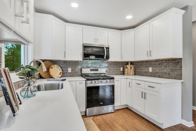 31340 N Liberty Rd, Grayslake, IL 60030 - kitchen featuring appliances with stainless steel finishes, light countertops, white cabinetry, light wood-style floors, and recessed lighting