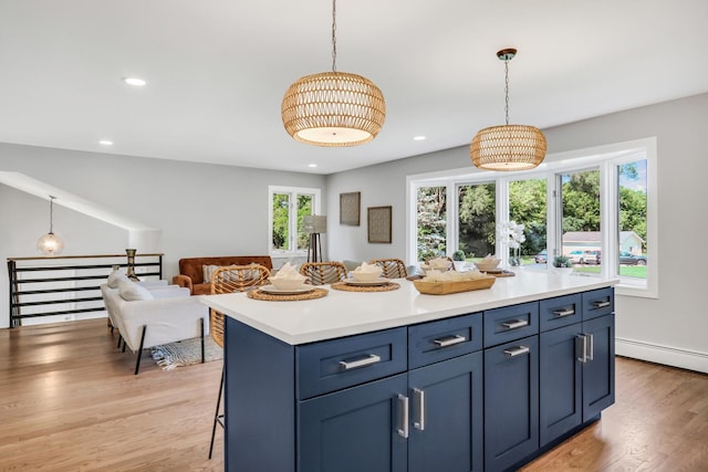 31340 N Liberty Rd, Grayslake, IL 60030 - kitchen featuring baseboard heating, light countertops, light wood-type flooring, open floor plan, and decorative light fixtures