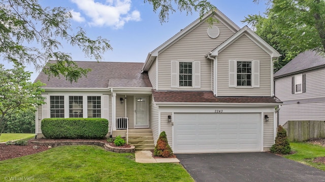 2243 Camden Ln, Hanover Park, IL 60133 - view of front of property with driveway, a garage, and roof with shingles