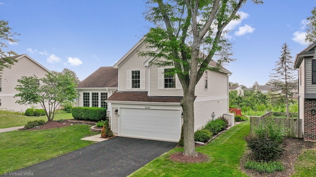 2243 Camden Ln, Hanover Park, IL 60133 - view of front of home featuring driveway, an attached garage, a front yard, and a shingled roof