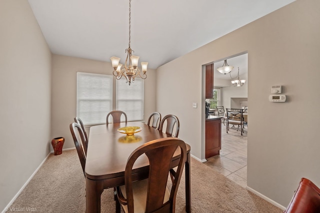 2243 Camden Ln, Hanover Park, IL 60133 - dining space featuring a chandelier, light colored carpet, and light tile patterned floors
