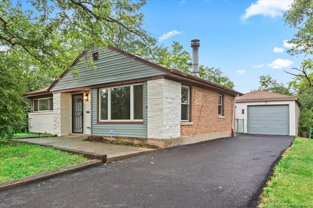 214 Marquette St, Park Forest, IL 60466 - bungalow-style house with an outdoor structure, driveway, a garage, and brick siding