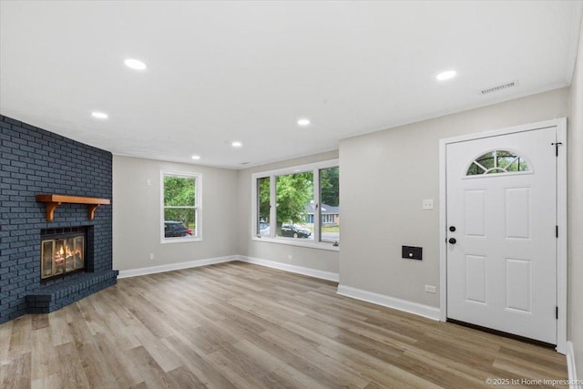 214 Marquette St, Park Forest, IL 60466 - foyer entrance with wood finished floors, a brick fireplace, and recessed lighting