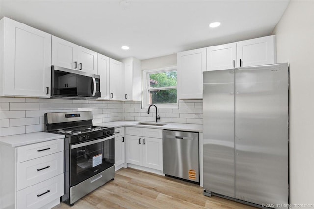 214 Marquette St, Park Forest, IL 60466 - kitchen with stainless steel appliances, light countertops, white cabinetry, backsplash, and recessed lighting