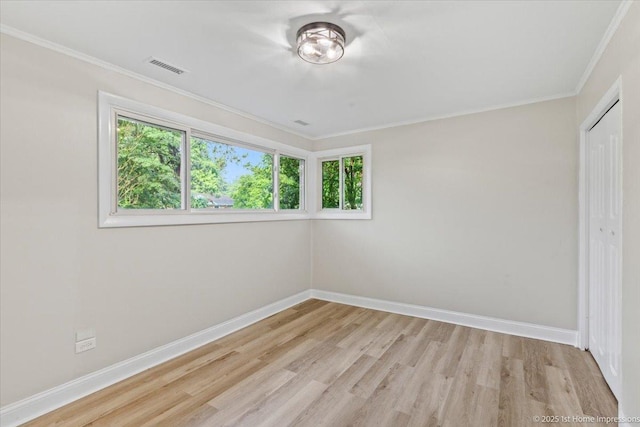 214 Marquette St, Park Forest, IL 60466 - unfurnished bedroom featuring light wood-style floors, crown molding, and a closet