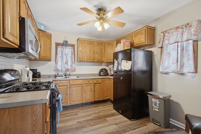 240 Miami St, Park Forest, IL 60466 - kitchen with black appliances, ceiling fan, light wood-style floors, tasteful backsplash, and light countertops