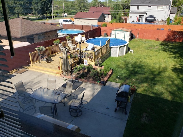 452 S Walnut St, Bensenville, IL 60106 - fenced backyard featuring a wooden deck and a storage unit
