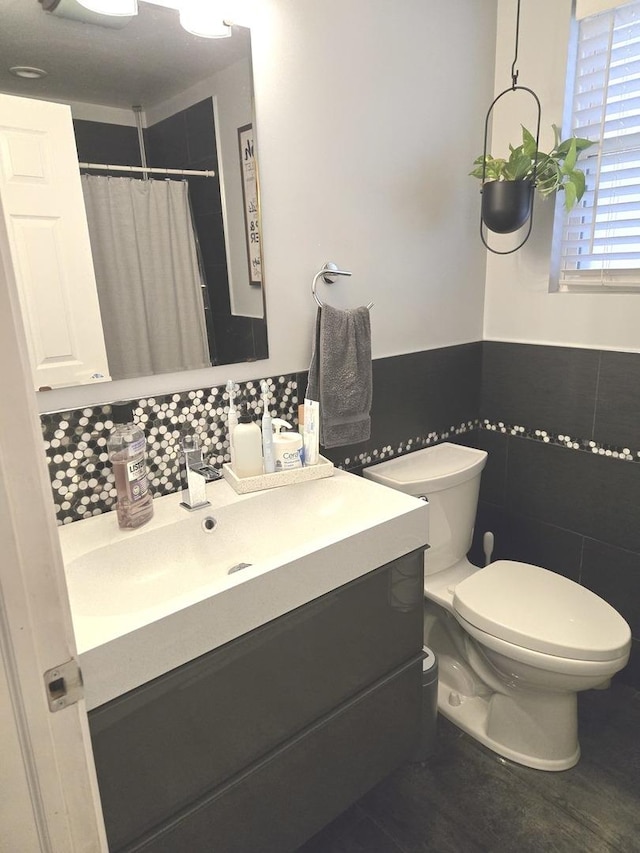 452 S Walnut St, Bensenville, IL 60106 - bathroom with vanity, wainscoting, tile walls, and a shower with shower curtain