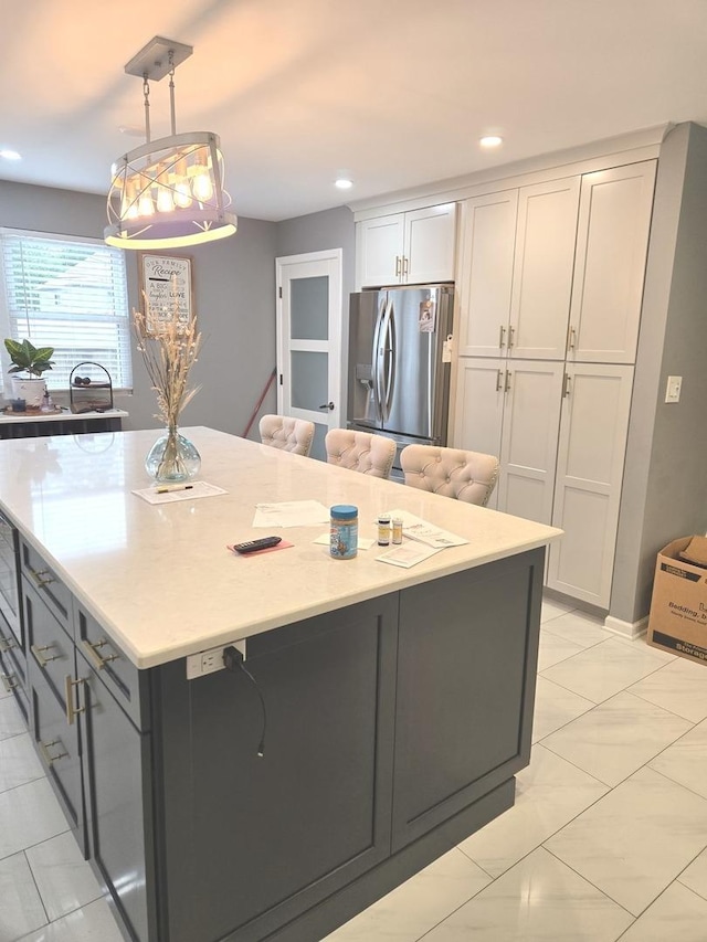 452 S Walnut St, Bensenville, IL 60106 - kitchen with stainless steel refrigerator with ice dispenser, light tile patterned floors, white cabinets, a large island, and pendant lighting