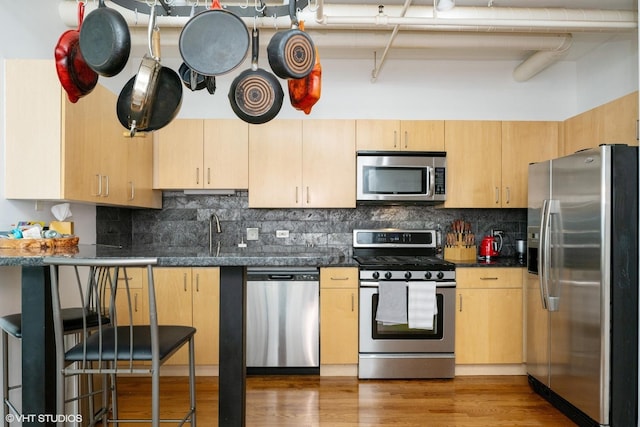 700 W Van Buren St Unit 803, Chicago, IL 60607 - kitchen featuring appliances with stainless steel finishes, tasteful backsplash, light brown cabinetry, and wood finished floors