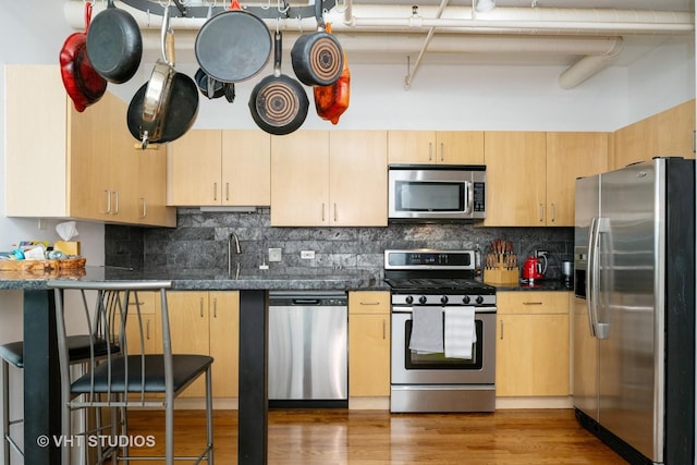 700 W Van Buren St Unit 803, Chicago, IL 60607 - kitchen with appliances with stainless steel finishes, backsplash, and light brown cabinetry