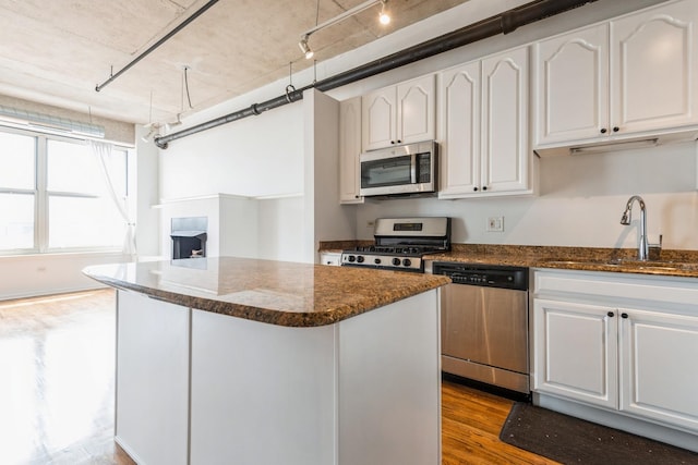 6 S Laflin St Unit 712, Chicago, IL 60607 - kitchen with stainless steel appliances, dark stone countertops, dark wood-style floors, and white cabinets