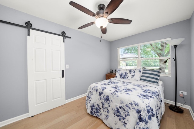 17011 Le Claire Ave, Tinley Park, IL 60477 - bedroom featuring a barn door, light wood finished floors, and ceiling fan
