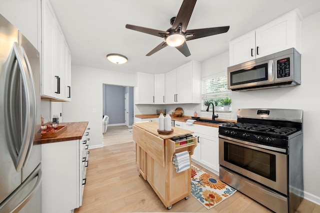 17011 Le Claire Ave, Tinley Park, IL 60477 - kitchen featuring butcher block counters, stainless steel appliances, a ceiling fan, light wood-type flooring, and white cabinets