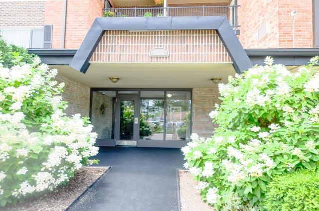 1206 S New Wilke Rd Unit 108, Arlington Heights, IL 60005 - view of exterior entry featuring brick siding and french doors