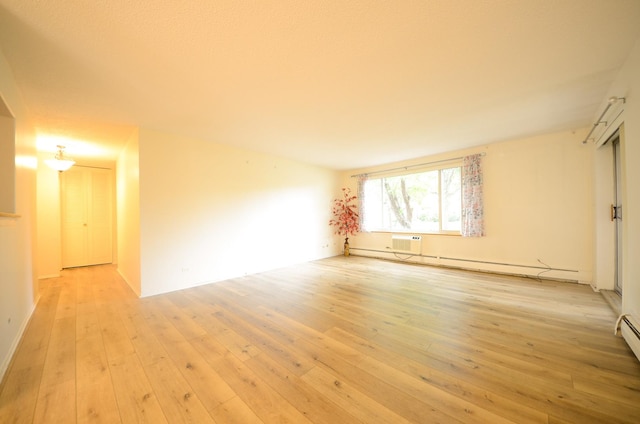 1206 S New Wilke Rd Unit 108, Arlington Heights, IL 60005 - unfurnished room with light wood-type flooring, an AC wall unit, and baseboard heating