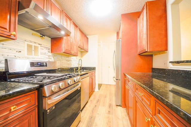 1206 S New Wilke Rd Unit 108, Arlington Heights, IL 60005 - kitchen featuring appliances with stainless steel finishes, wall chimney range hood, light wood-style floors, decorative backsplash, and dark stone counters